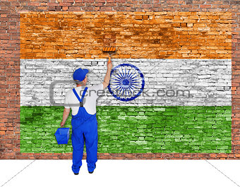 House painter covers brick wall with flag of India