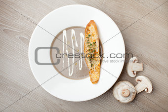 Vegetarian mushroom cream soup purÃ©e with baked bread cheese sl