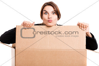 Business woman appear inside a big card box