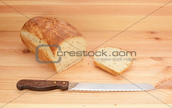 Bread knife with freshly sliced loaf of bread 