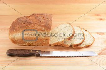 Three slices cut from a loaf of bread with a knife