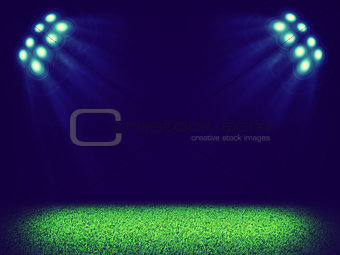 Spotlights illuminating area of grass court
