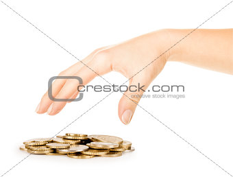 coins fall out of the hands on a pile of gold coins