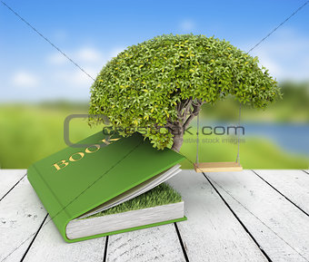 Tree of knowledge growing out of book on the nature background