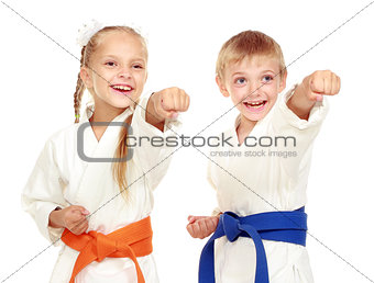 Girl and boy in a kimono on a white background beat hand