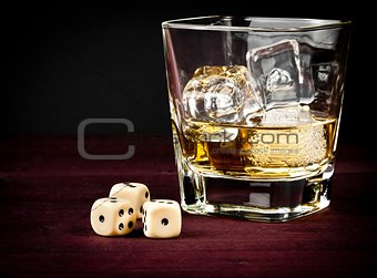 dice near whiskey glass, concept of game