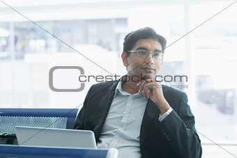 Indian business man having a thought at airport