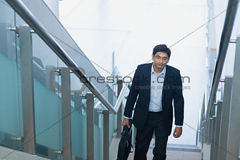 Asian Indian businessman ascending steps