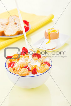 Delicious breakfast. Corn flakes with milk and strawberries.