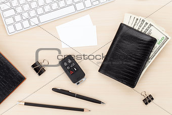 Office table with pc, supplies, business cards and money cash