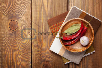 Wood kitchen utensils and spices over wooden table