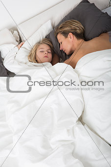 Mother and Daughter sleeping in bed