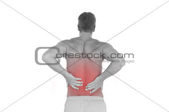 Shirtless man suffering from lower back pain