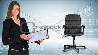 Businesswoman showing blank clipboard. Office chair beside