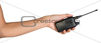 Female hand holding portable radio transmitter