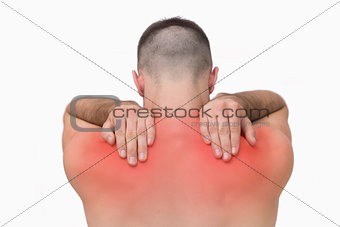 Rear view of shirtless man with shoulder pain