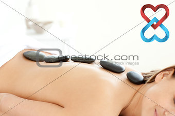 Composite image of attractive woman receiving a spa treatment