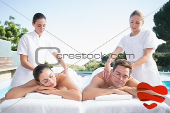 Composite image of calm couple enjoying couples massage poolside
