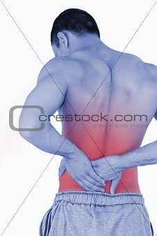 Young male suffering from back pain