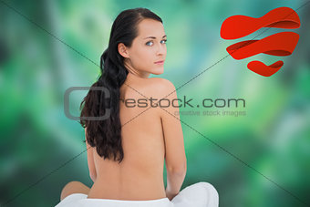 Composite image of beautiful brunette posing nude with towel at waist