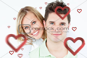 Composite image of portrait of a young happy couple standing against a white background