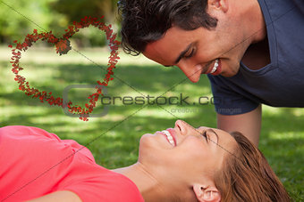 Composite image of man smiling as he looks down into his friends eyes