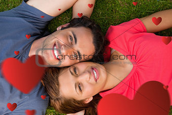 Composite image of two friends looking upwards while lying head to shoulder