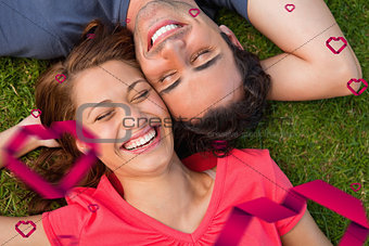 Composite image of two friends smiling while lying head to shoulder with an arm behind their head