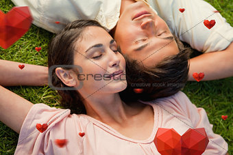 Composite image of man and a woman lying head to shoulder with their arm behind their neck