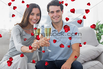 Composite image of portrait of lovers toasting their flutes of champagne