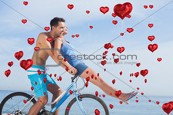 Composite image of man giving girlfriend a lift on his crossbar
