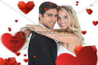 Composite image of beautiful bride embracing her husband
