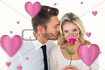 Composite image of handsome man kissing girlfriend on cheek holding a rose