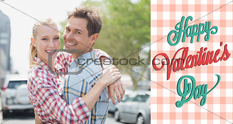 Composite image of couple in check shirts and denim hugging each other