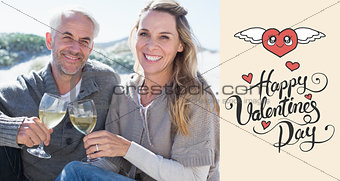 Composite image of couple enjoying white wine on picnic at the beach smiling at camera