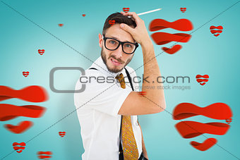 Composite image of geeky hipster scratching his head