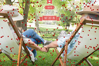 Composite image of mature couple sitting in deck chairs at park