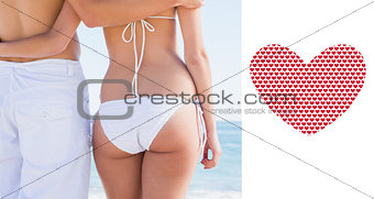 Composite image of rear mid section of fit couple facing the sea