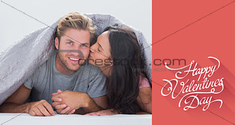 Composite image of woman kissing her husband