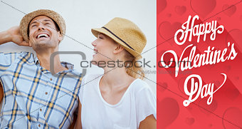 Composite image of young hip couple laughing on bench