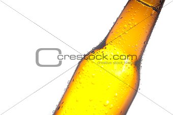 detail of tilted bottle of fresh beer with drops, with space for text