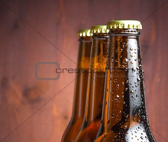 three bottles of fresh beer with drops