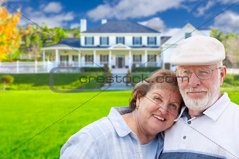 Happy Senior Couple in Front of House