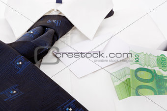 Dress shirt, envelope and money. Business still life.