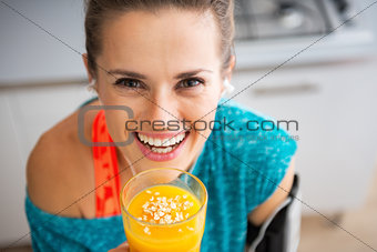 Portrait of happy fitness young woman with pumpkin smoothie