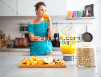 Close-up on pumpkin smoothie and ingredients on table and fitnes