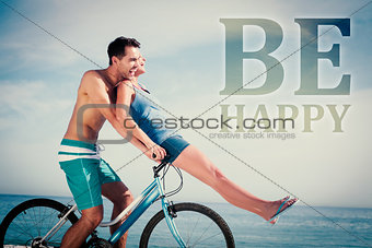 Composite image of man giving girlfriend a lift on his crossbar
