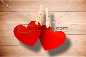 Composite image of hearts hanging on line