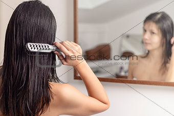 Woman brushing her wet hair