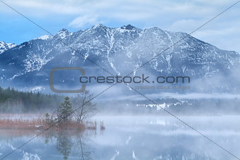 Karwendel mountains and Barmsee lake in foggy morning
